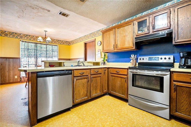 8170 Wilmer Georgetown Rd, Wilmer, AL 36587 - kitchen with a notable chandelier, a peninsula, under cabinet range hood, visible vents, and stainless steel appliances