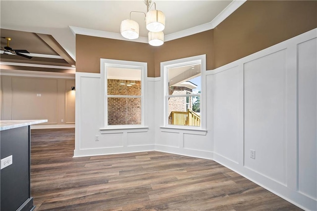 unfurnished dining area with ornamental molding, dark hardwood / wood-style floors, and ceiling fan with notable chandelier