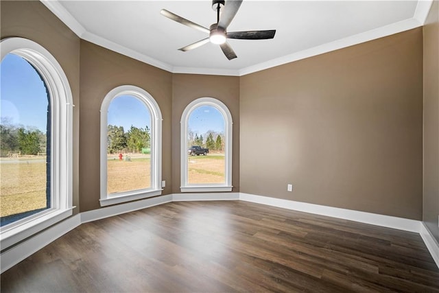 spare room featuring ceiling fan, ornamental molding, and dark hardwood / wood-style floors