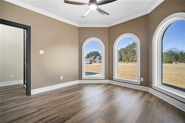 spare room with crown molding, dark hardwood / wood-style floors, and ceiling fan