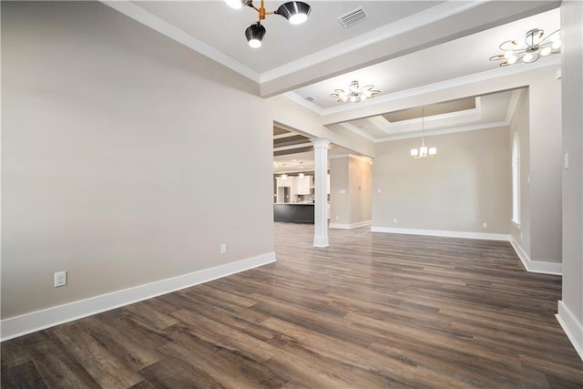 unfurnished living room with dark wood-type flooring, a chandelier, a raised ceiling, crown molding, and decorative columns