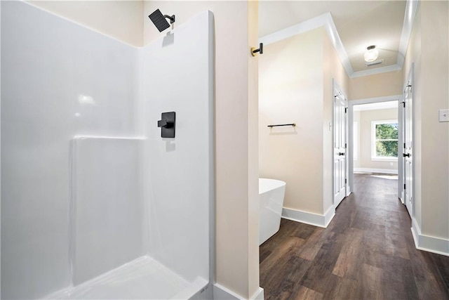 bathroom with hardwood / wood-style floors, crown molding, and shower with separate bathtub