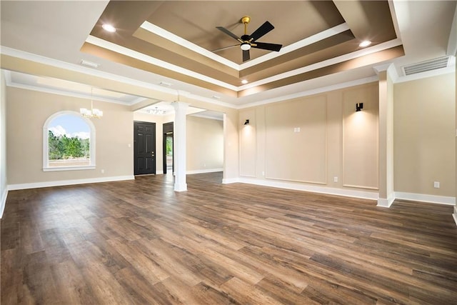 unfurnished room with ornamental molding, ceiling fan with notable chandelier, dark hardwood / wood-style flooring, and a raised ceiling