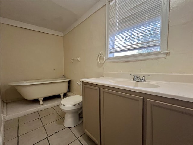 bathroom with vanity, a tub, toilet, and tile patterned flooring