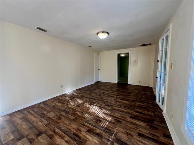 unfurnished room featuring french doors and dark wood-type flooring