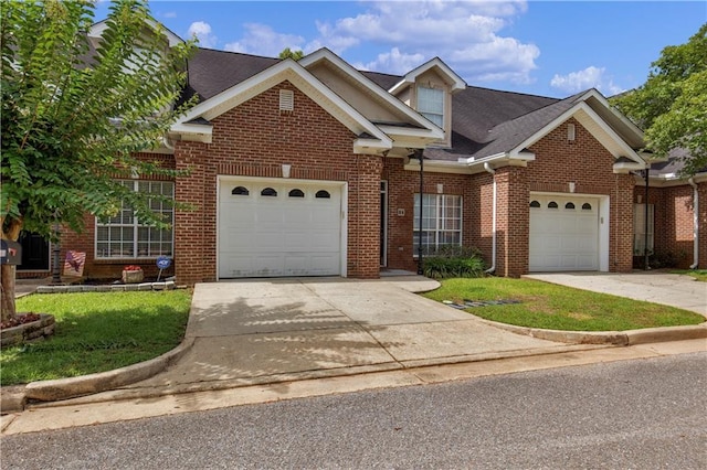 211 W Dr Unit 34, Mobile, AL 36608 - traditional-style house with driveway, brick siding, a garage, roof with shingles, and a front yard