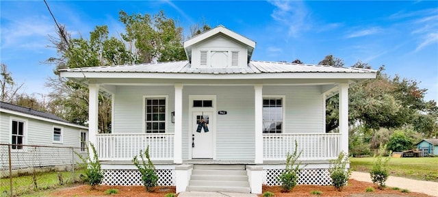 view of front of house featuring covered porch and metal roof