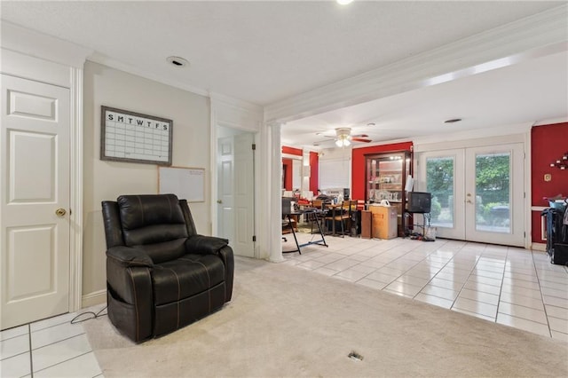 sitting room featuring tile patterned floors, french doors, carpet, crown molding, and ceiling fan