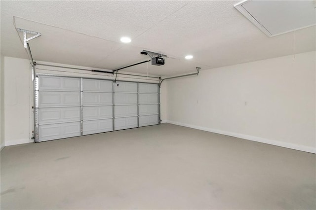 garage with a garage door opener and baseboards