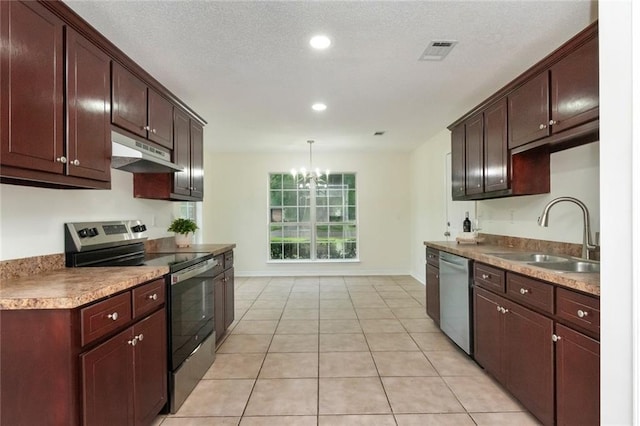 kitchen featuring a chandelier, light tile patterned floors, under cabinet range hood, appliances with stainless steel finishes, and a sink