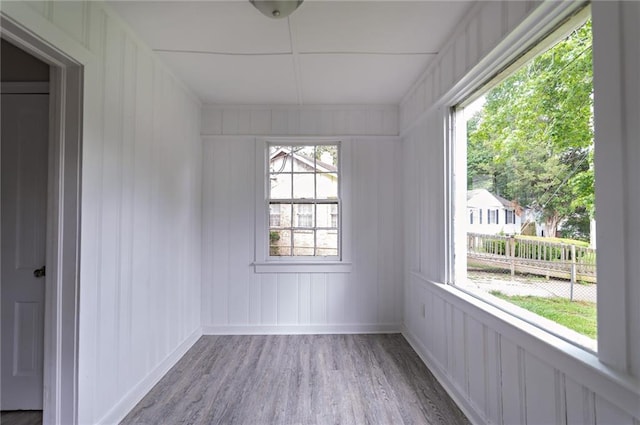 empty room featuring a wealth of natural light and hardwood / wood-style flooring