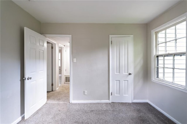 unfurnished bedroom with light carpet