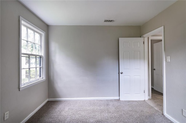 unfurnished room featuring carpet flooring and a wealth of natural light