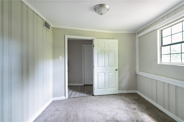 unfurnished bedroom featuring light carpet