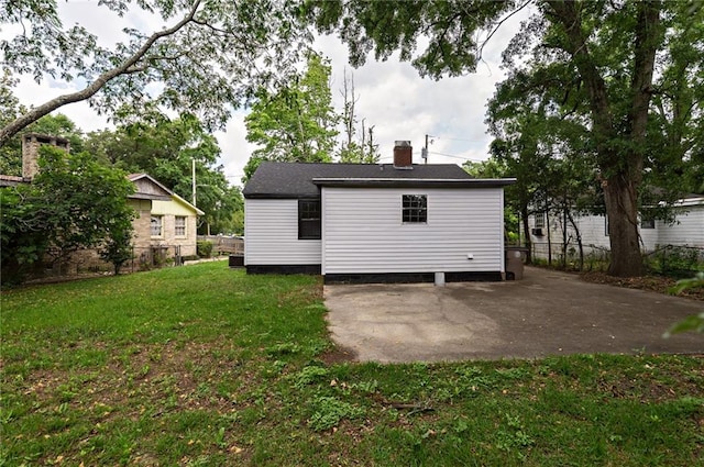 back of property featuring a yard