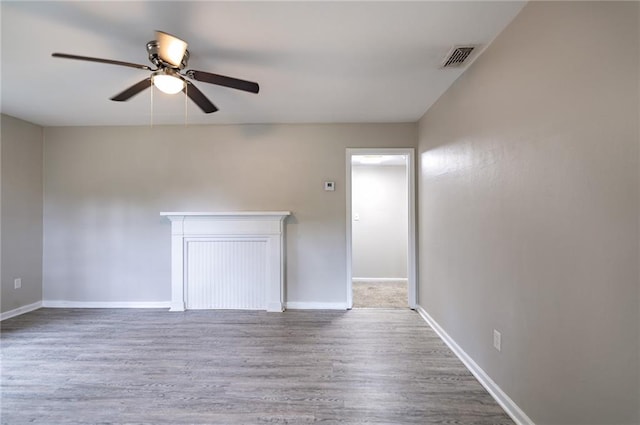 empty room with ceiling fan and hardwood / wood-style floors