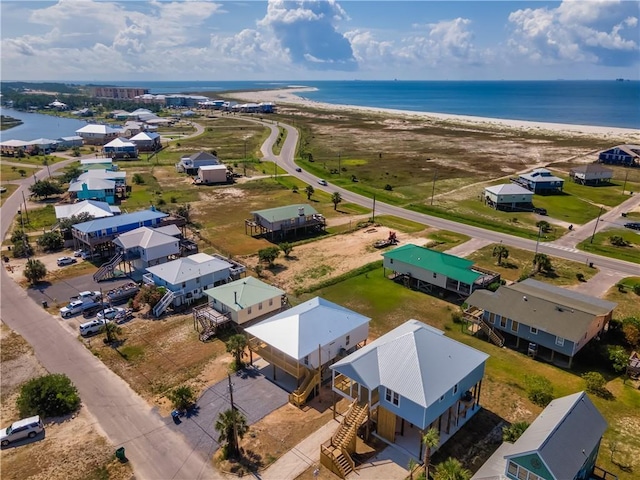 aerial view with a water view and a view of the beach