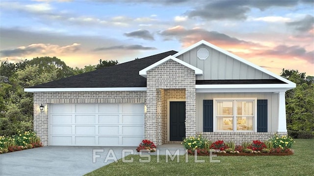 view of front of property with a yard and a garage