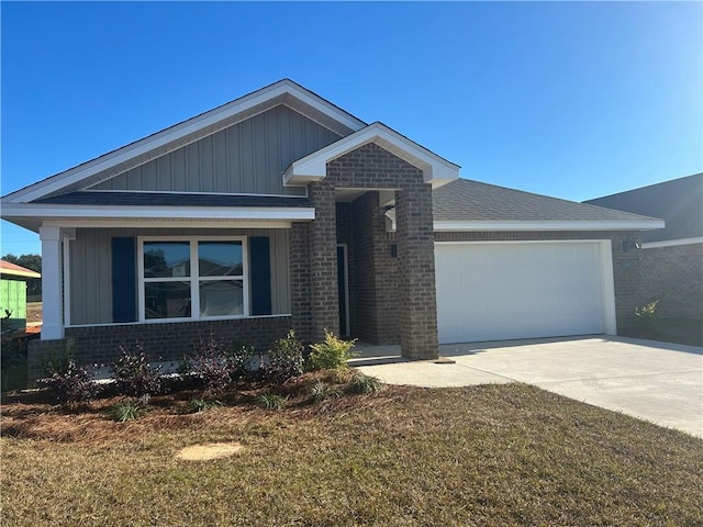 ranch-style home with driveway, board and batten siding, a front yard, brick siding, and a garage