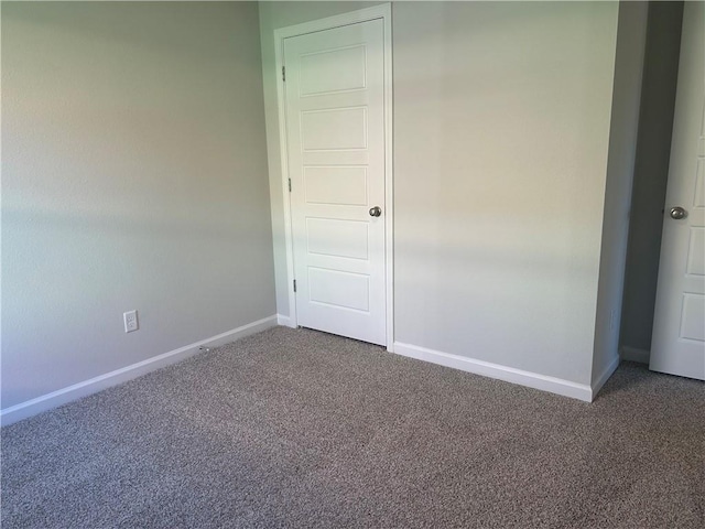 unfurnished bedroom featuring carpet and baseboards
