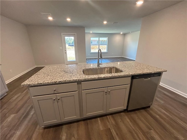 kitchen featuring a center island with sink, dishwasher, sink, and dark wood-type flooring