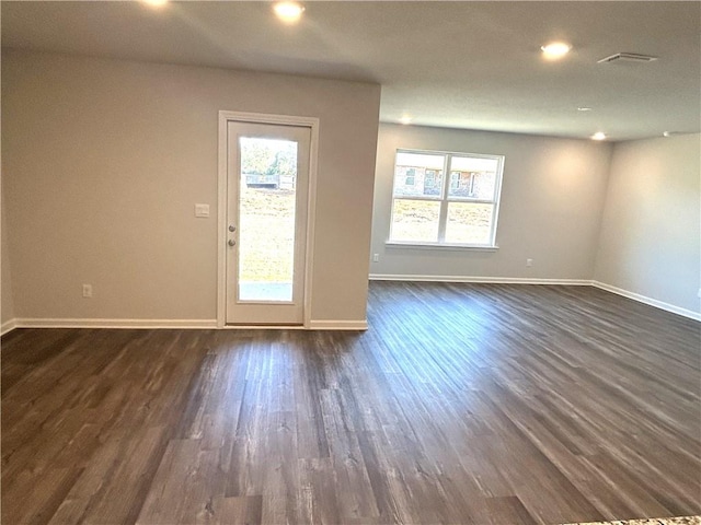 empty room with dark hardwood / wood-style flooring