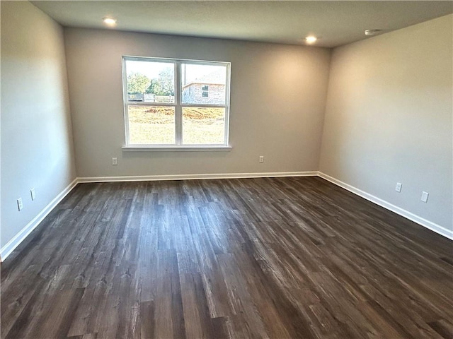 unfurnished room featuring dark wood-type flooring