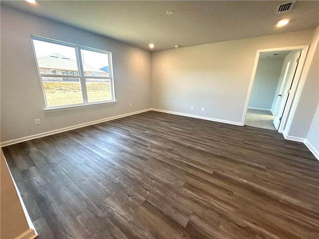 spare room featuring dark wood-type flooring