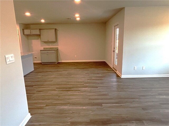 unfurnished living room with dark hardwood / wood-style flooring