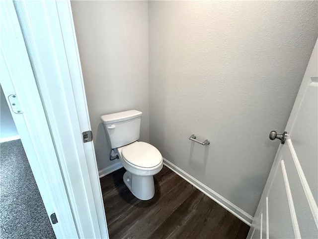 bathroom with hardwood / wood-style flooring and toilet