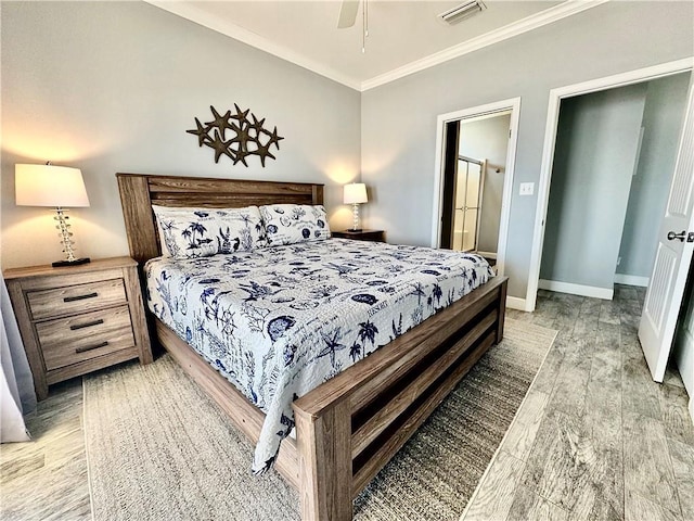 bedroom featuring visible vents, ensuite bath, light wood-style floors, crown molding, and baseboards