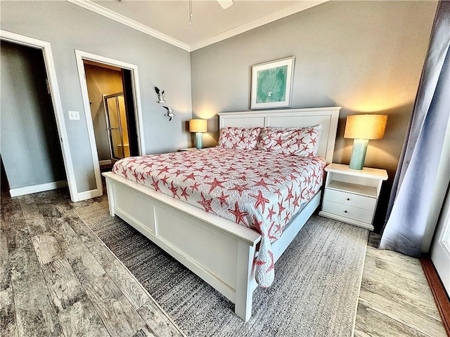 bedroom featuring crown molding, wood finished floors, and baseboards