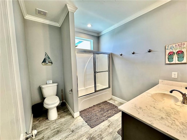 bathroom featuring visible vents, toilet, crown molding, baseboards, and bath / shower combo with glass door