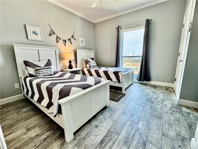 bedroom featuring baseboards, wood tiled floor, and crown molding