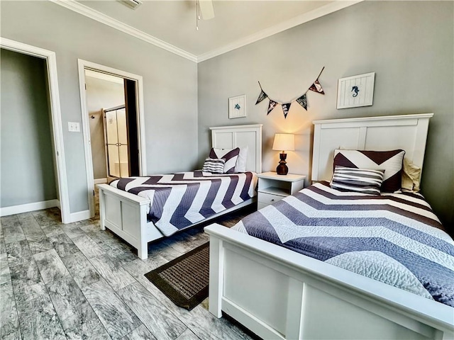 bedroom with a ceiling fan, crown molding, baseboards, and wood tiled floor