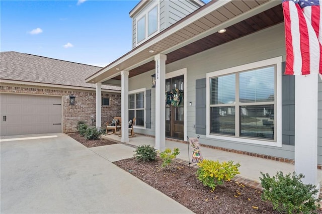 property entrance featuring a garage and covered porch