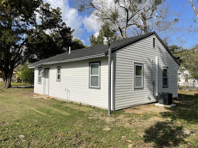 view of home's exterior with central AC and a lawn