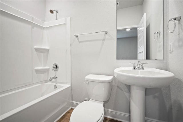 full bath with toilet, shower / tub combination, wood finished floors, and baseboards