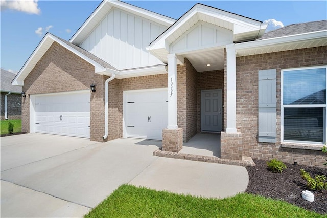 view of front of house featuring concrete driveway, a garage, board and batten siding, and brick siding
