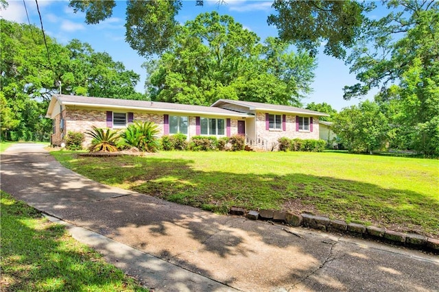 1215 Anchor Dr, Mobile, AL 36693 - view of front of house featuring a front lawn, brick siding, and driveway