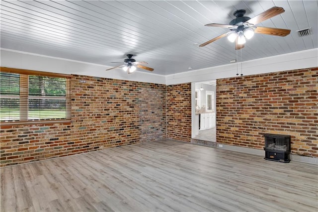 1215 Anchor Dr, Mobile, AL 36693 - unfurnished living room featuring brick wall, ceiling fan, a wood stove, wood finished floors, and wood ceiling
