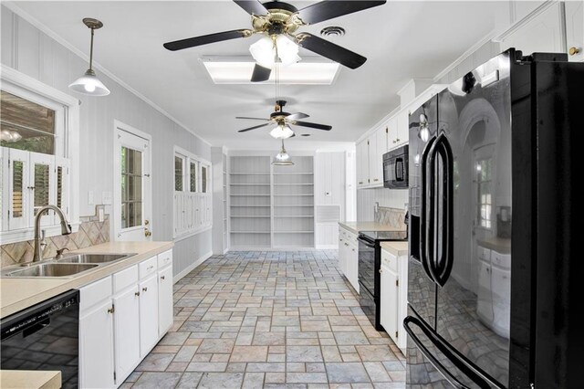 1215 Anchor Dr, Mobile, AL 36693 - kitchen featuring black appliances, a sink, a ceiling fan, crown molding, and white cabinetry
