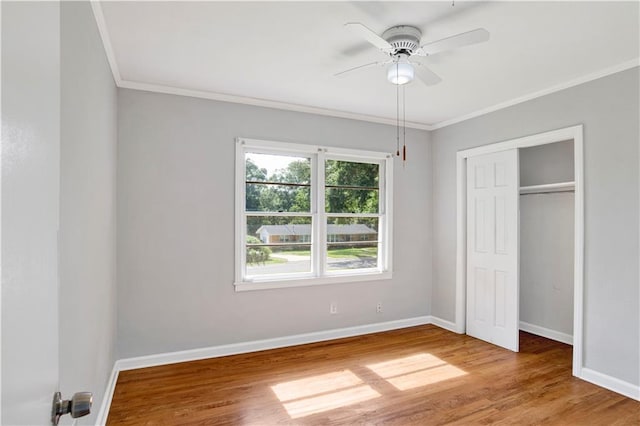 1215 Anchor Dr, Mobile, AL 36693 - unfurnished bedroom featuring crown molding, baseboards, wood finished floors, a closet, and a ceiling fan
