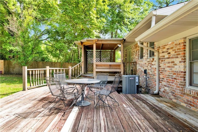 1215 Anchor Dr, Mobile, AL 36693 - deck featuring a fenced backyard, outdoor dining area, and central air condition unit
