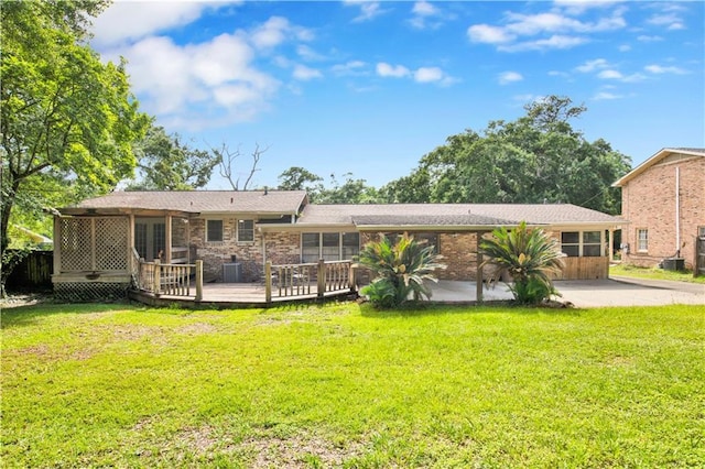 1215 Anchor Dr, Mobile, AL 36693 - rear view of house with a yard, a wooden deck, brick siding, and central AC