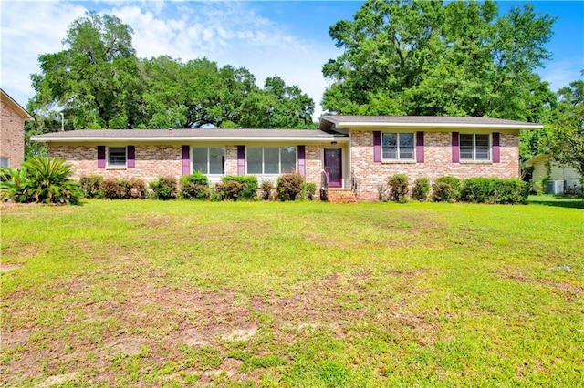 1215 Anchor Dr, Mobile, AL 36693 - split level home featuring brick siding, a front lawn, and central AC unit