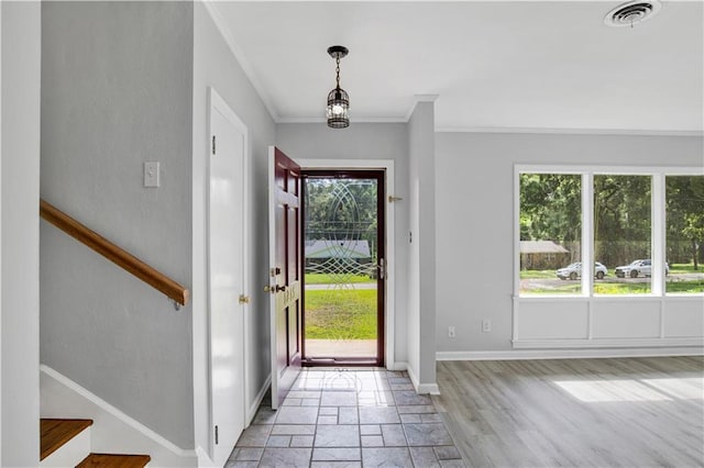1215 Anchor Dr, Mobile, AL 36693 - foyer entrance with plenty of natural light, stone tile flooring, ornamental molding, stairs, and baseboards