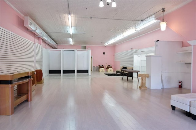 misc room with a chandelier and light wood-type flooring