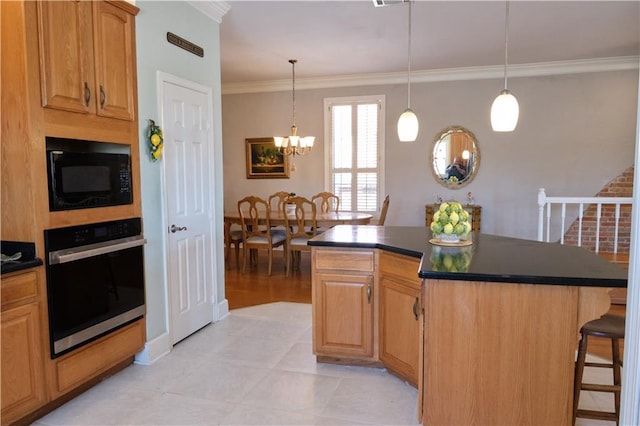 kitchen with pendant lighting, black microwave, a notable chandelier, a kitchen breakfast bar, and stainless steel oven