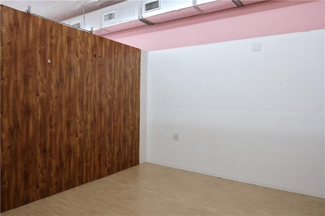 unfurnished room featuring hardwood / wood-style flooring